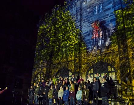 A choir performing at a past Light Up Lancaster event at Lancaster Castle