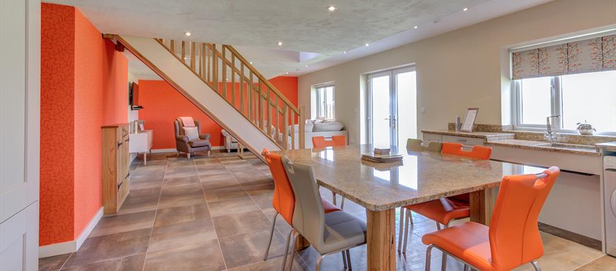Open living space decorated in orange and white