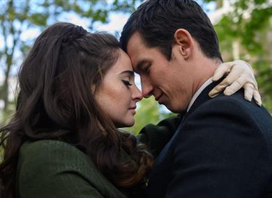 A couple face each other in a loving pose.