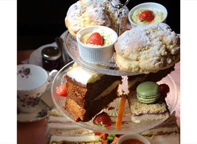 Afternoon tea table display with three tiers of treats.