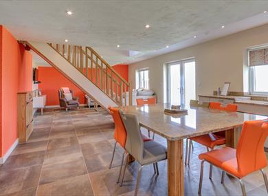 Open living space decorated in orange and white