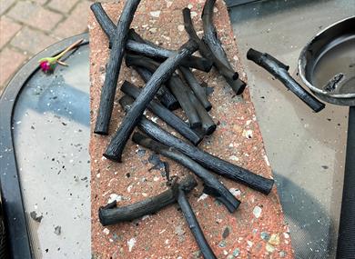 Image of charcoal sticks on a table.