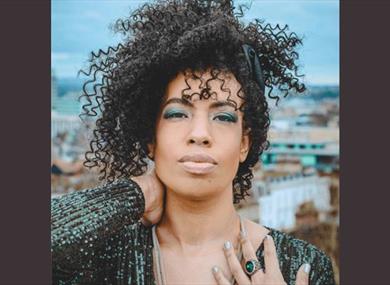 A photograph of the performer, photographed on a rooftop.