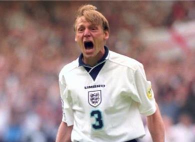 A photograph of Stuart celebrating on the pitch in an England national kit.