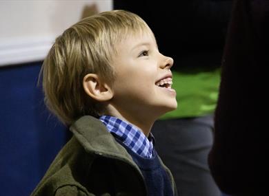 A child, with a beaming smile, enjoys his day.