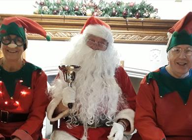 Santa with his elves photo
