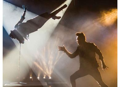 Dramatic image of the performance in the spotlight of the theatre.