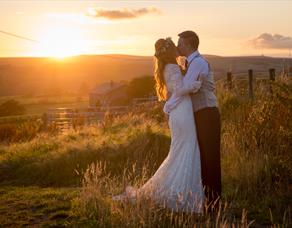 Kissing couple in front of sunset