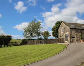 Image of outside the barn on a sunny day.