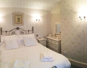 A double room with a comfortable double bed with white linen.