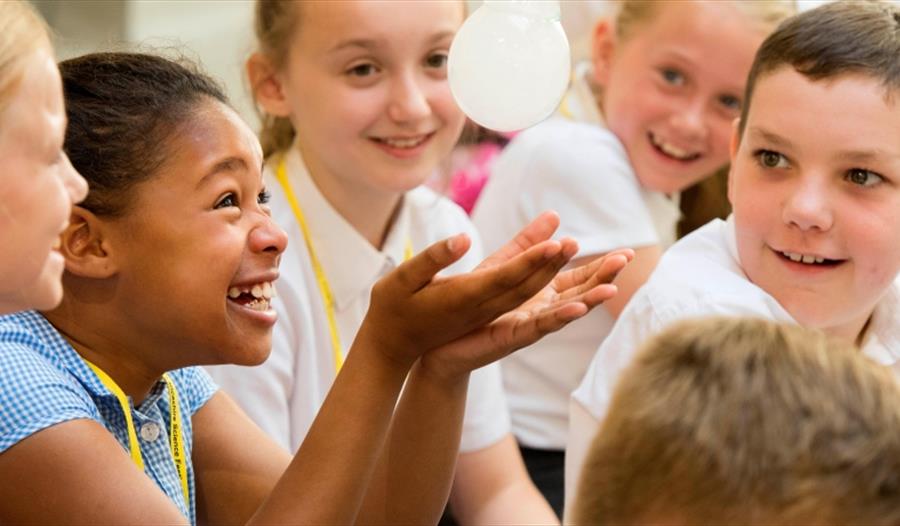 Children watch an experiment in fascination.