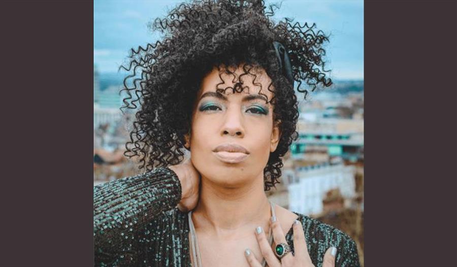 A photograph of the performer, photographed on a rooftop.
