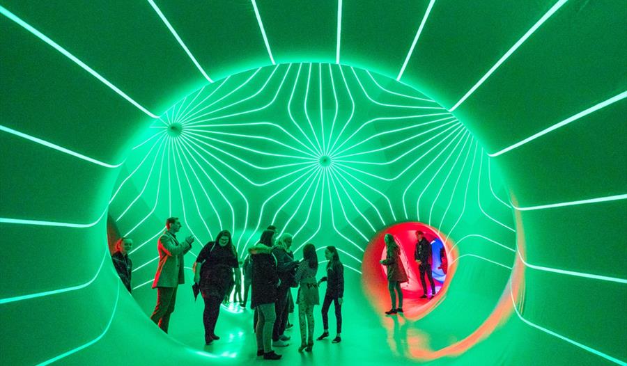 People inside the architects of air, surrounded by lights.