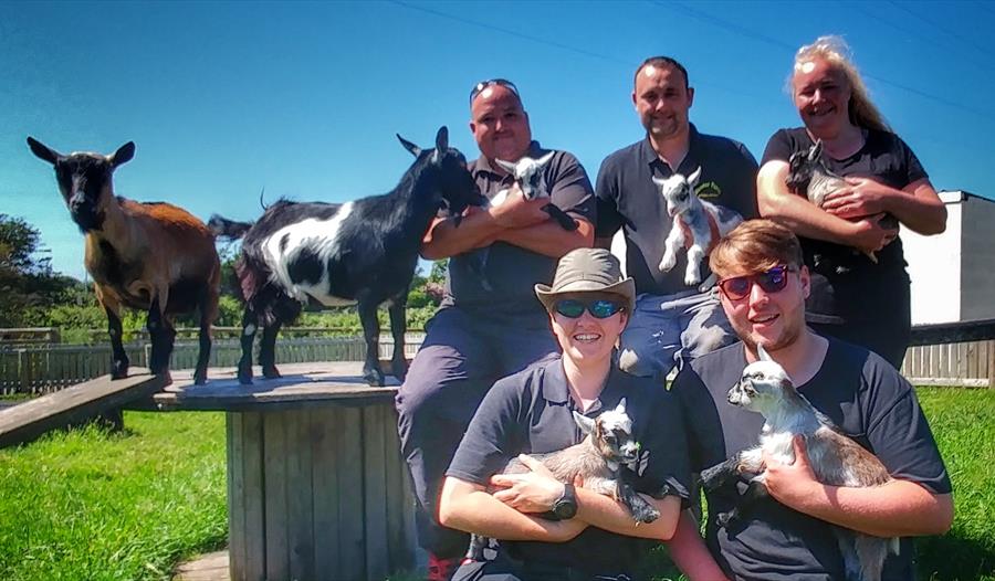 friend group posing with animals