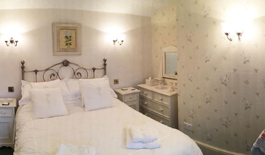 A double room with a comfortable double bed with white linen.