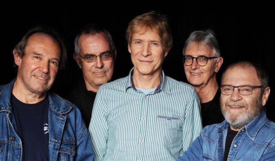 The five members of the group pose for a picture.