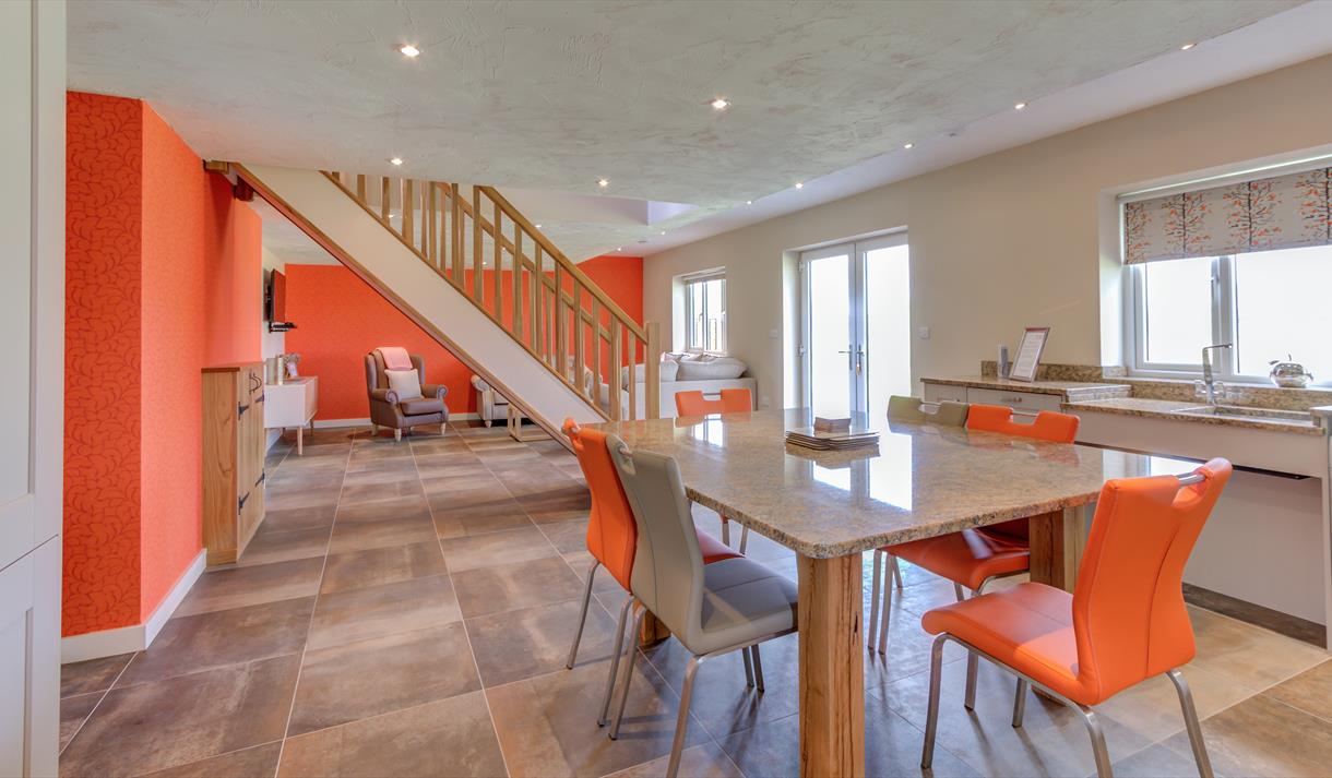 Open living space decorated in orange and white