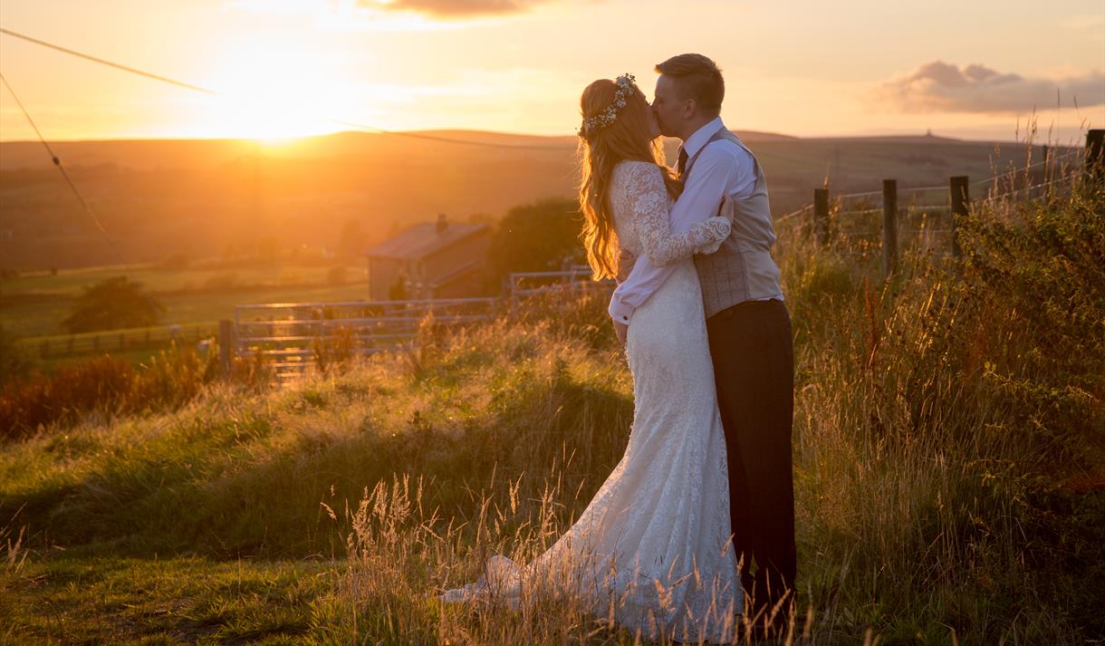 Kissing couple in front of sunset