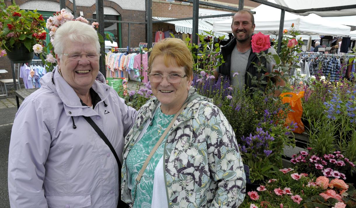 Shoppers at flower and plant stall