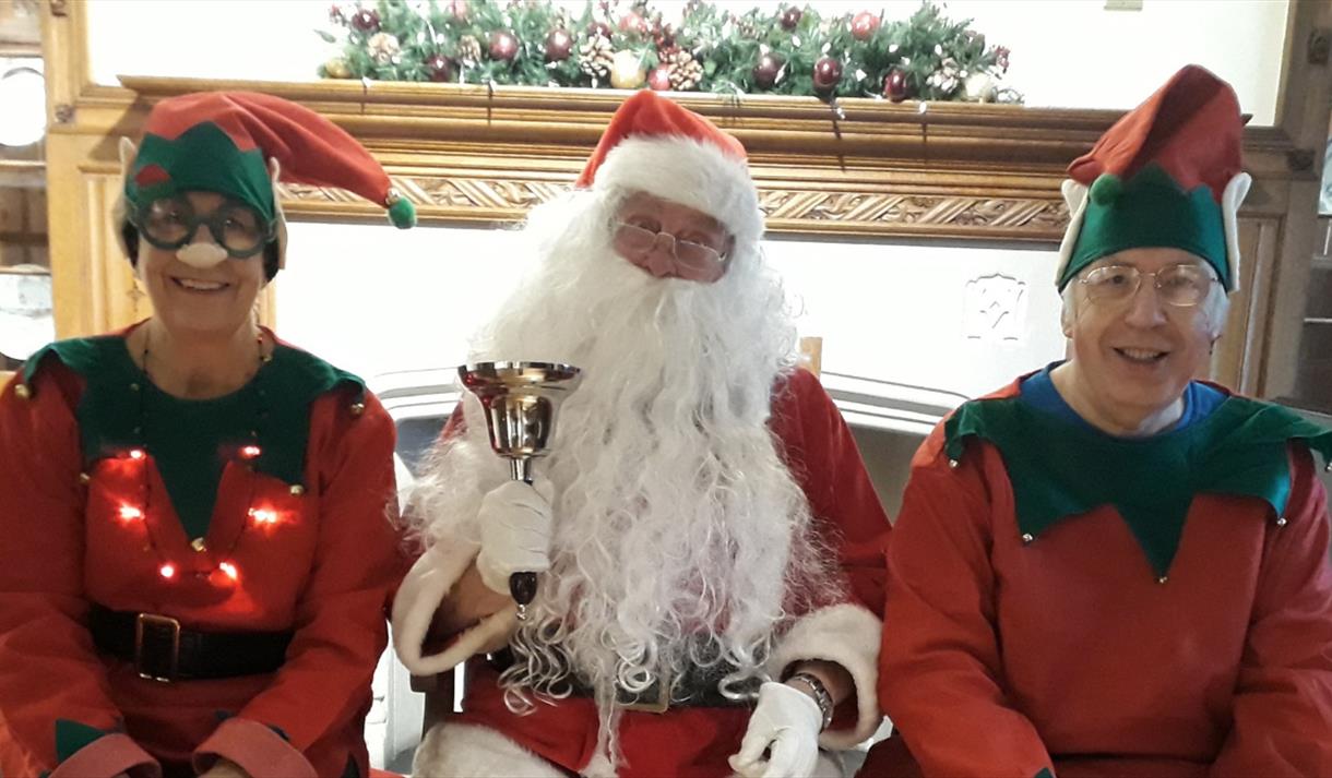 Santa with his elves photo