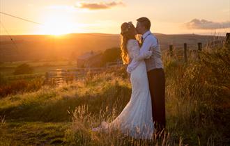 Kissing couple in front of sunset