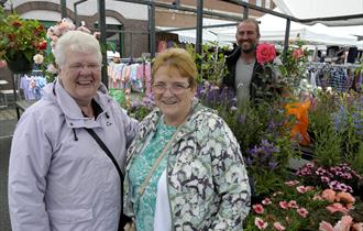 Shoppers at flower and plant stall