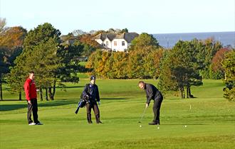 Playing golf at Morecambe Golf Course