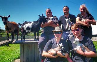 friend group posing with animals