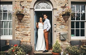 Happy couple at the front door