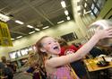 A girl is astonished at the science experiment she is taking part in.