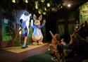 Peter Rabbit performs on stage for delighted children.