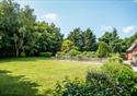 The spacious, tree lined garden of the farmhouse.