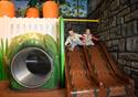 Two children slide down a slide in the world of Peter Rabbit.