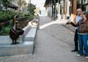 Couple stood pointing looking at Feathers McGraw