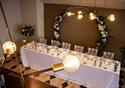 23 Winckley Square venue is dressed and prepared for a wedding reception.  A birds eye view of the top table with a large circle flower garland as the