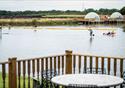 A view from a lodge patio, looking out over the lake and countryside.