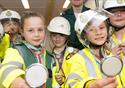 Children dress in emergency service uniforms.