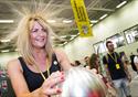 A lady takes part in an experiment that causes her hair to stand up on end.