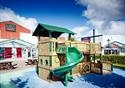 mage of the play area outside the M&S shop with a nautical theme and a curving green slide.