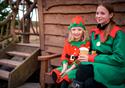 Cartoon couple in a festive scene on the farm with animals in Christmas hats