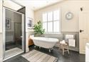 A spacious bathroom at the The Gatehouse, with a roll top bath.