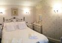 A double room with a comfortable double bed with white linen.