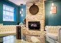 Bar area with white chesterfield sofa and chair