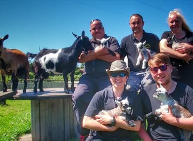 friend group posing with animals