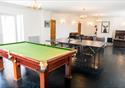 A games area in the farmhouse with a table tennis and pool table.