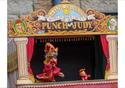 A traditional Punch and Judy puppet show scene setting.
