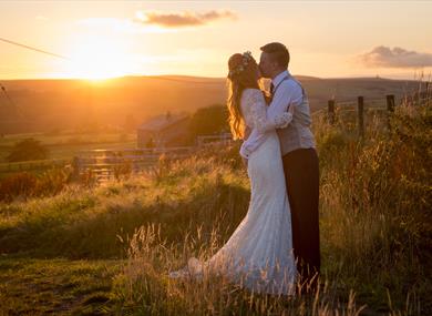 Kissing couple in front of sunset
