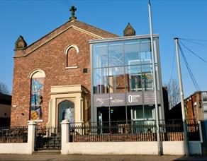 The Chapel Ormskirk.  An outside picture of the building, bathed in sunshine.