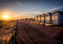 Promenade at sunset by St Annes Beach Huts