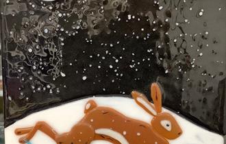 Running hare on moonlit snow. Arkglass